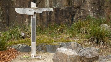 The cross bearing the names of those who lost their lives is seen in the Memorial Garden in the Port Arthur Historical Site