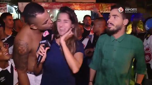 Brazilian journalist Bruna Dealtry was left shocked when she was kissed unexpectedly by a soccer fan live-on-air. Picture: Esporte Interativo.
