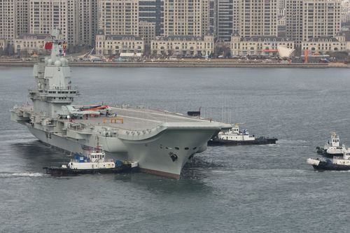 Tugboats undock China's first homemade aircraft carrier in Dalian city, north-east China.