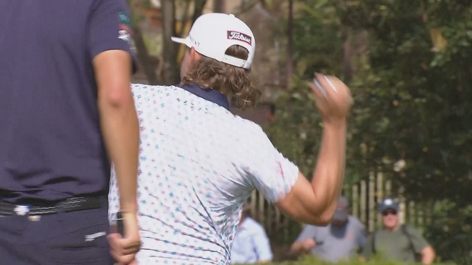 Cameron Smith throws his ball into the pond after making bogey at the 17th.