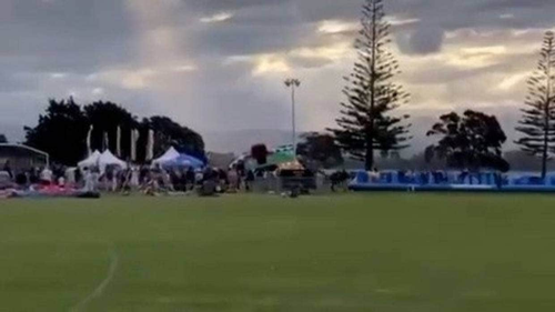 A still from video of the bouncy castle as it blew away during a New Year's festival in Tauranga.