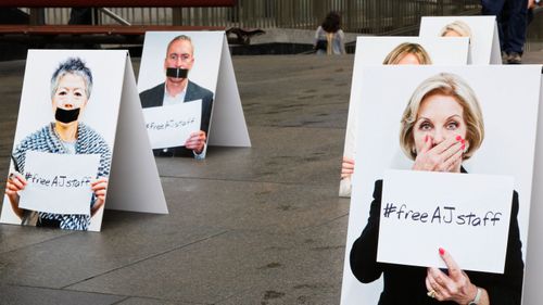 Protesters set up placards during a rally for detained Australian journalist Peter Greste in Martin Place, Sydney (AAP Image/Tanja Bruckner)