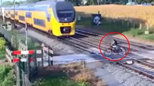 Dutch cyclist almost hit by speeding train