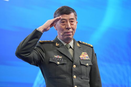 Chinese Defence Minister Li Shangfu salutes before delivering his speech on the last day of the 20th International Institute for Strategic Studies (IISS) Shangri-La Dialogue, Asia's annual defence and security forum, in Singapore, on June 4, 2023. 
