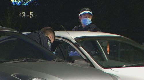 Police examine a car after the stabbing in Adelaide.