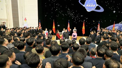 North Korean leader Kim Jong-Un (C) giving a speech during a party for scientists who contributed to the launch of the earth observation satellite Kwangmyong in Pyongyang