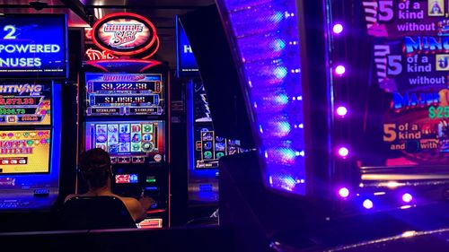 A lone gambler plays the pokie machines in a Sydney venue.