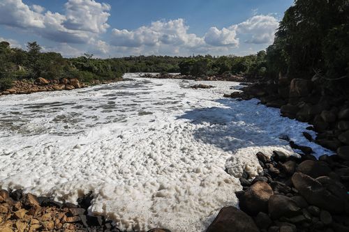 Foam flows over the surface of the Tiete River in Salto, Sao Paulo state, Brazil, Wednesday, Oct. 13, 2021. 