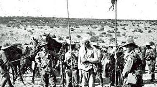 Australian cavalry troops and captured Turkish soldiers shortly after the fall of Beersheba. (Photo: Australian War Memorial).