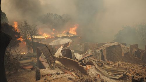 It is believed many of the homes in Tathra were filled with asbestos, which has since been stirred up and mixed into the air as a result of the bushfire, causing a major health issue for anyone nearby. Picture: AAP.