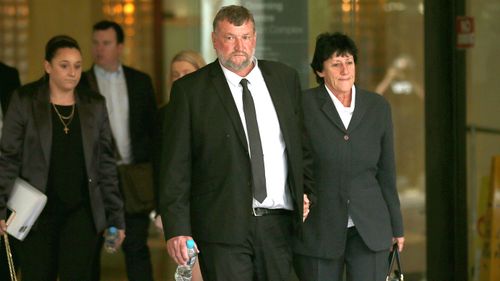 Greg and Virginia Hughes, the parents of dead cricketer Phillip Hughes, leave the Downing Centre, after attending the coronial inquiry into the death of their son. 
