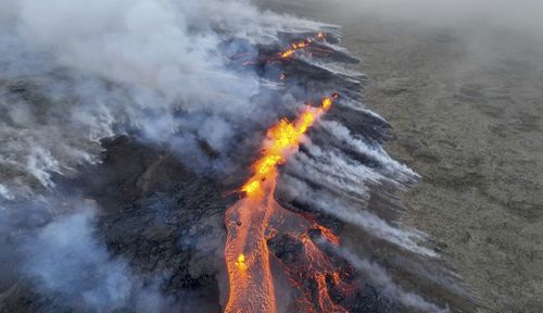 In this image taken from a video, Lava emerges from a fissure of the Fagradalsfjall volcano near the Litli-Hrútur mountain, some 30 kilometres southwest of Reykjavik, Iceland, Monday July 10, 2023.  