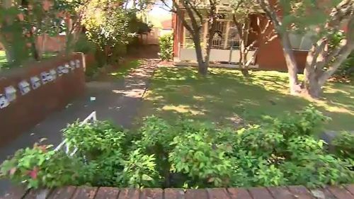 The woman ran into a front yard in Ashfield last night when a man placed a cable bike lock around her neck. (9NEWS)