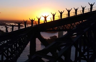 BridgeClimb Sydney -- climbers scaling the Sydney Harbour Bridge at dawn