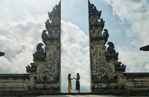 Tourists pose at the gate of heaven at Lempuyang temple in Bali.