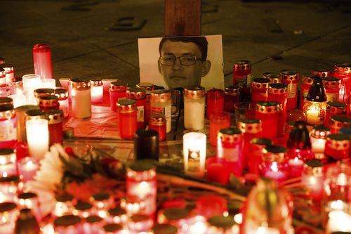 People light candles as they pay respect to the Slovak investigative reporter Jan Kuciak and his girlfriend Martina Kusnirova in Prague, Czech Republic, February 26, 2018. Investigative reporters Jan Kuciak, working for the Aktuality.sk online news portal, and his girlfriend were murdered in Slovakia this weekend, while his work was the most probable motive. Photo/Kamil Kosun (CTK via AP Images)