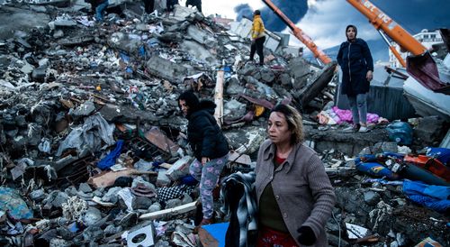 Earthquake survivors wait for news of their loved ones, believed to be trapped under collapsed building  in Iskenderun, Turkey. 