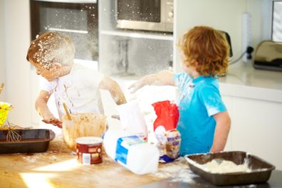 Kids playing in the kitchen. Kids misbehaving. Little boys playing in the kitchen.