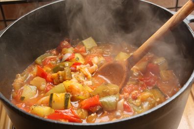 Ratatouille cooking in a cast iron casserole dish