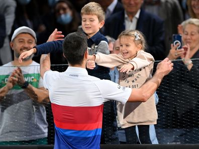 Novak Djokovic of Serbia celebrates with his son, Stefan Djokovic (L) and daughter, Tara Djokovic (R) after winning the men's singles final at the Paris Masters, 2021. 