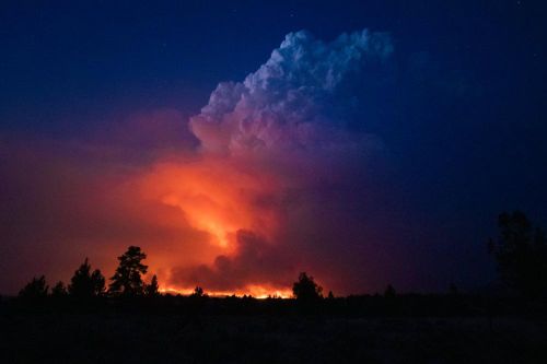 In this photo provided by the Oregon Office of State Fire Marshal, flames and smoke rise from the Bootleg Fire in southern Oregon on Wednesday, July 14, 2021. (John Hendricks/Oregon Office of State Fire Marshal via AP)