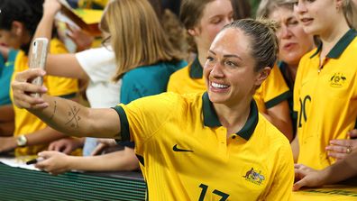 Matildas star Kyah Simon takes selfies with fans after her team's victory against New Zealand on April 8, 2022. 