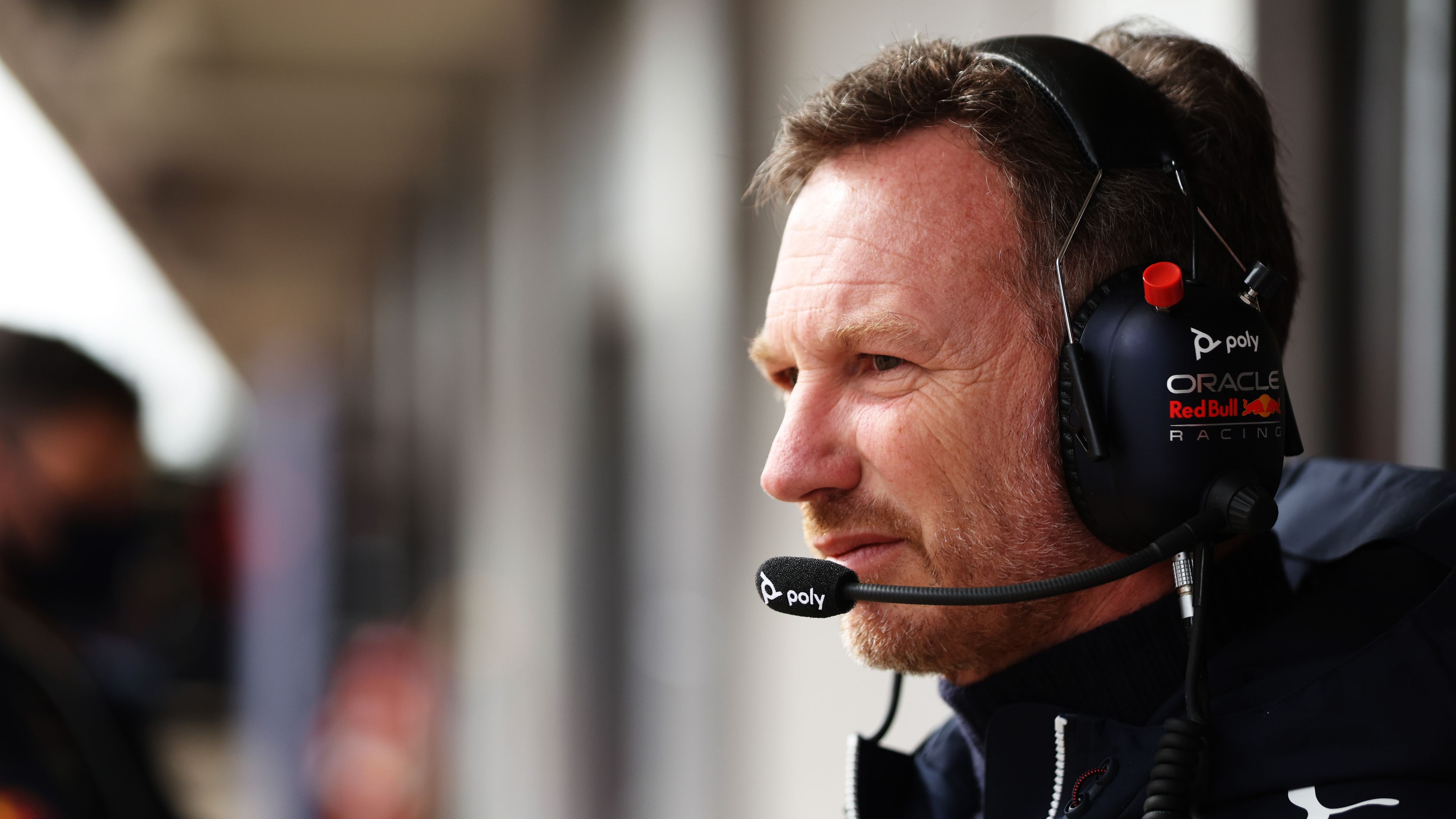 Red Bull Racing Team Principal Christian Horner looks on in the garage.
