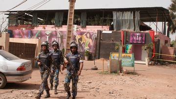 Armed forces patrol the rear of the nightclub. (AAP)