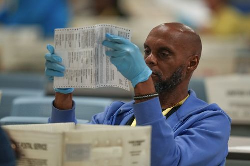 An election worker processes mail-in ballots for the 2024 General Election at the Philadelphia Election Warehouse, Tuesday, Nov. 5, 2024, in Philadelphia. (AP Photo/Matt Slocum)