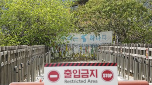 A banner and ribbons wishing reunification of the two Koreas are displayed on the wire fence at the Imjingak Pavilion in Paju, near the border with North Korea. 