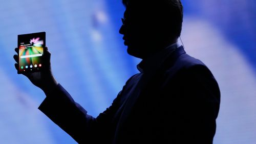 Justin Denison, SVP of Mobile Product Development, shows off the Infinity Flex Display of a folding smartphone during the keynote address of the 2018 Samsung Developer Conference.