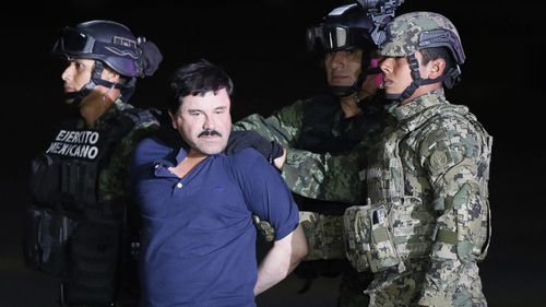 Mexican drug lord Joaquin 'El Chapo' Guzman is escorted by the authorities to a Mexican Army helicopter in 2016, to be transferred to the prison from which he escaped on 11 July 2015.