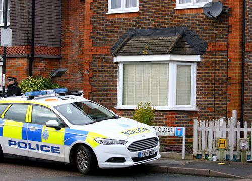 Police outside the home in Crawley, West Sussex, of 47-year-old man and 54-year-old woman who were released without charge in connection with the drone incidents at Gatwick Airport.