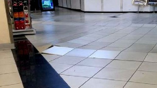 Tiles were dislodged from the floor of the Coles store. (9NEWS)