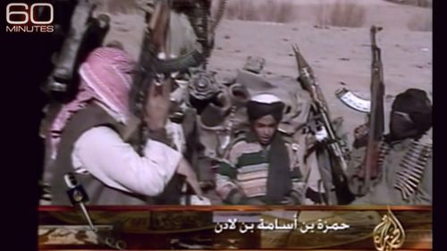 Hamza bin Laden sits between armed fighters from the al Qaeda group. Source: 60 Minutes