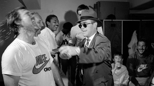 Elton John celebrates with England captain Mike Gatting after England won the 4th Test match between Australia and England at Melbourne, Australia, in 1986. 
 (Patrick Eagar, Popperfoto, Getty Images)