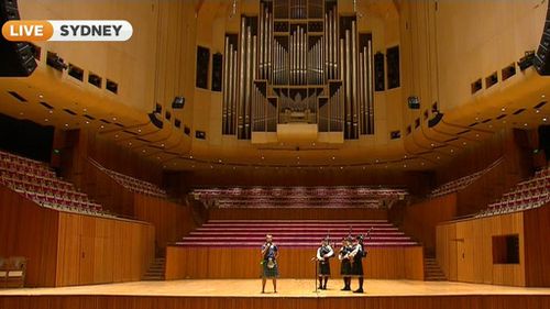 Cancer survivor Greig Trout onstage at the Sydney Opera House. (9NEWS)