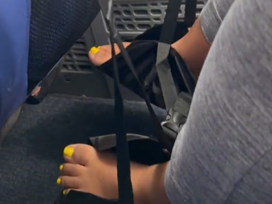 Woman in the US causes a stir with her bare foot sling on a plane.