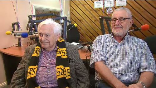 Tommy Carter sits draped in Richmond colours in the Casey radio station studio.