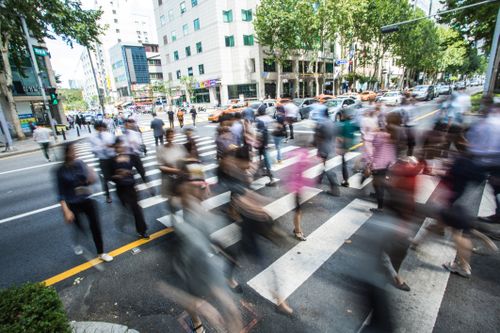 Motion blurred Crowd, unrecognizable pedestrians crossing over the  street in Seoul, South Korea