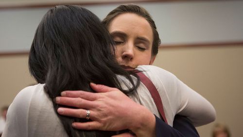 Victim Rachael Denhollander (R) hugs a fellow victim. (AAP)