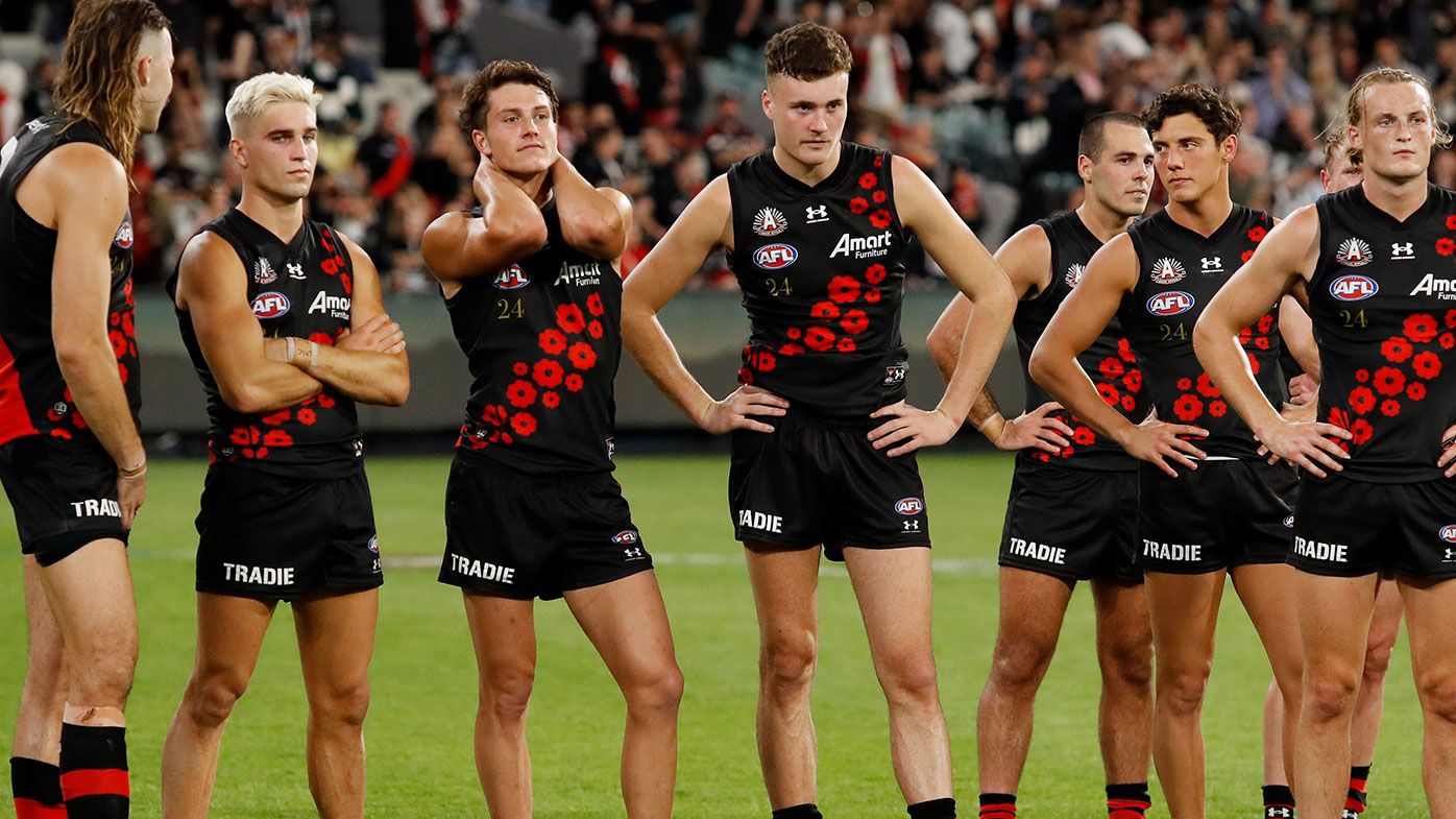Essendon players look dejected after the loss to Collingwood on Anzac Day.