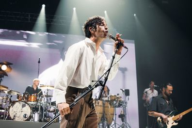 Matt Healy, the lead singer of British band The 1975, slammed Malaysia's anti-LGBTQ laws and kissed a bandmate on stage on July 21. Healy is seen here performing earlier this year at a concert in Paris.
