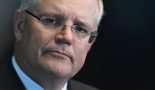 Treasurer Scott Morrison has said a strengthening economy means he can fund the National Disability Insurance Scheme (NDIS) without a Medicare levy hike, but disability groups aren't convinced. (AAP)