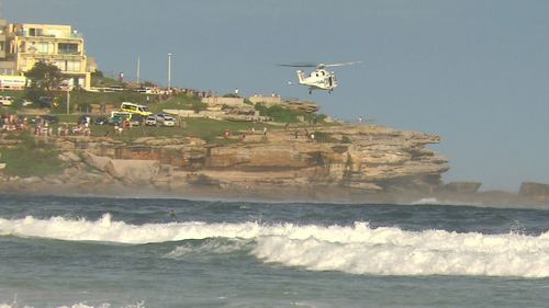 A rescue helicopter was called in to help locate the man in rough surf. 