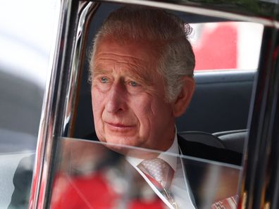 King Charles pictured in 2022, looking out of a car window.