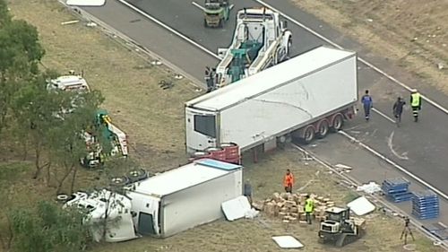 The truck careered across two lanes and hit an unoccupied car parked in an emergency stopping lane. (9NEWS)