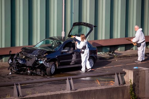 Forensic experts secure evidences on a crashed car involved in the series of motorway accidents in Berlin. 