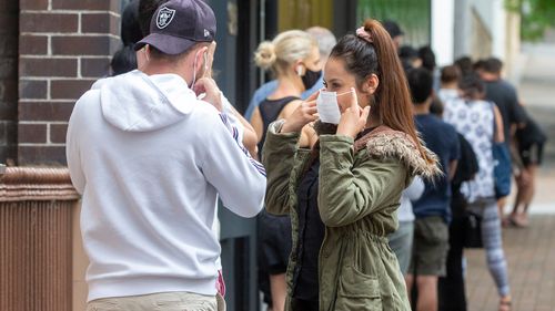 People are seen lining up at a COVID-19 testing centre at the East Sydney Community and Arts Centre in Darlinghurst, Sydney. Sydney's northern beaches is on lockdown, as a cluster of COVID-19 cases continues to grow causing other Australian states and territories to impose restrictions on travel ahead of the Christmas holidays.