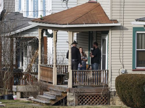 An Ohio authorities trooper goes doorway to doorway telling residents to time off downtown East Palestine, Ohio, connected Sunday, Feb. 5, 2023.  